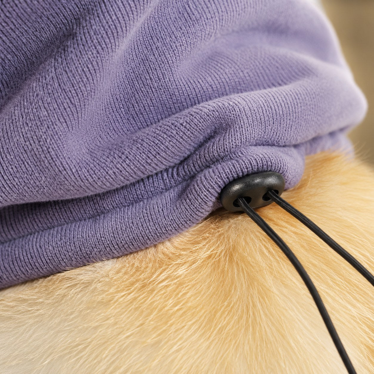 Close-up of the soft lavender fleece and drawstring toggle of the PupHush snood